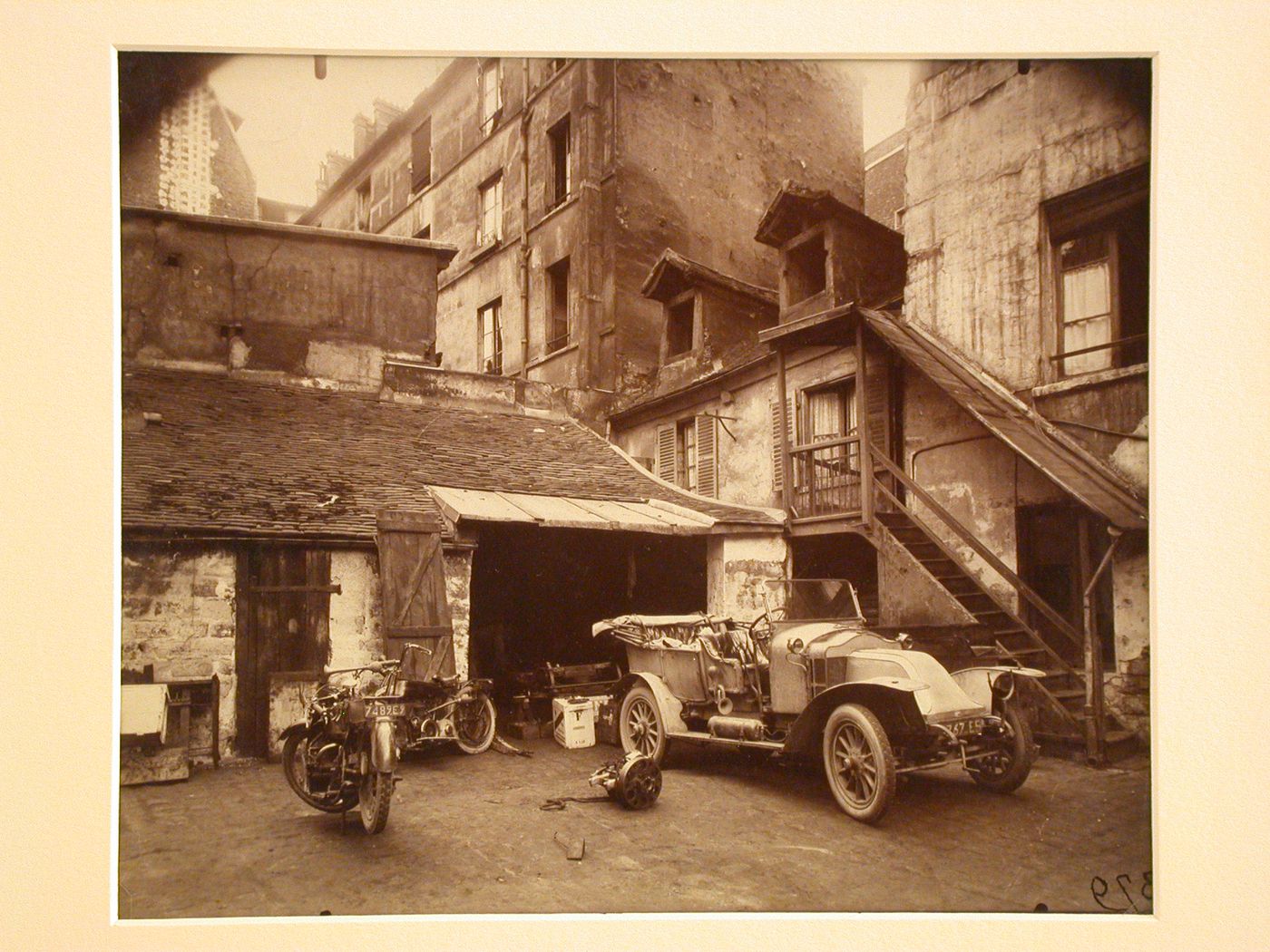 Car, motorcycle, and garage, Cour, Rue de Valence, Paris, France