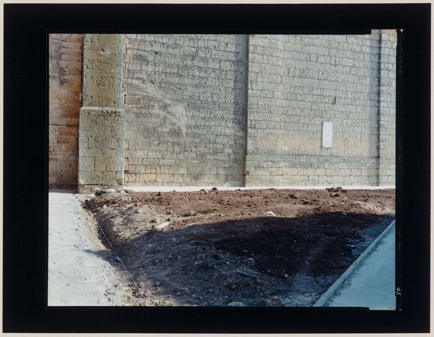 View of a stone wall and a landscape bed or building site, Villasandino, Spain (from the series "In between cities")