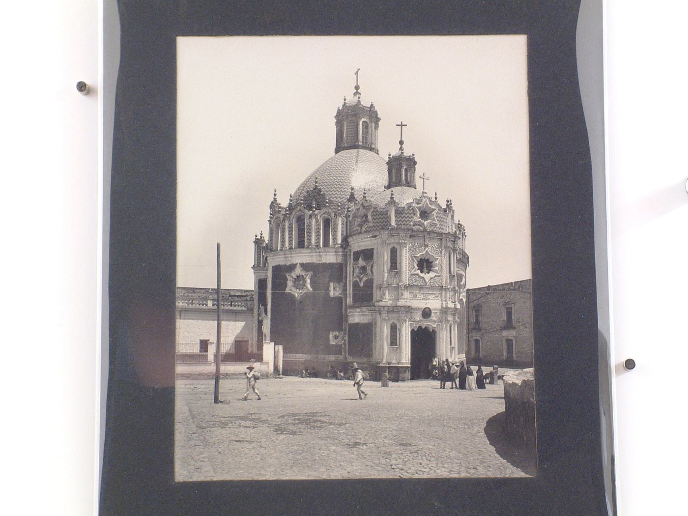 View of the Capilla del Pocito showing a square in the foreground with people throughout, Guadalupe Hidalgo (now Gustavo A. Madero, in Mexico City), Mexico