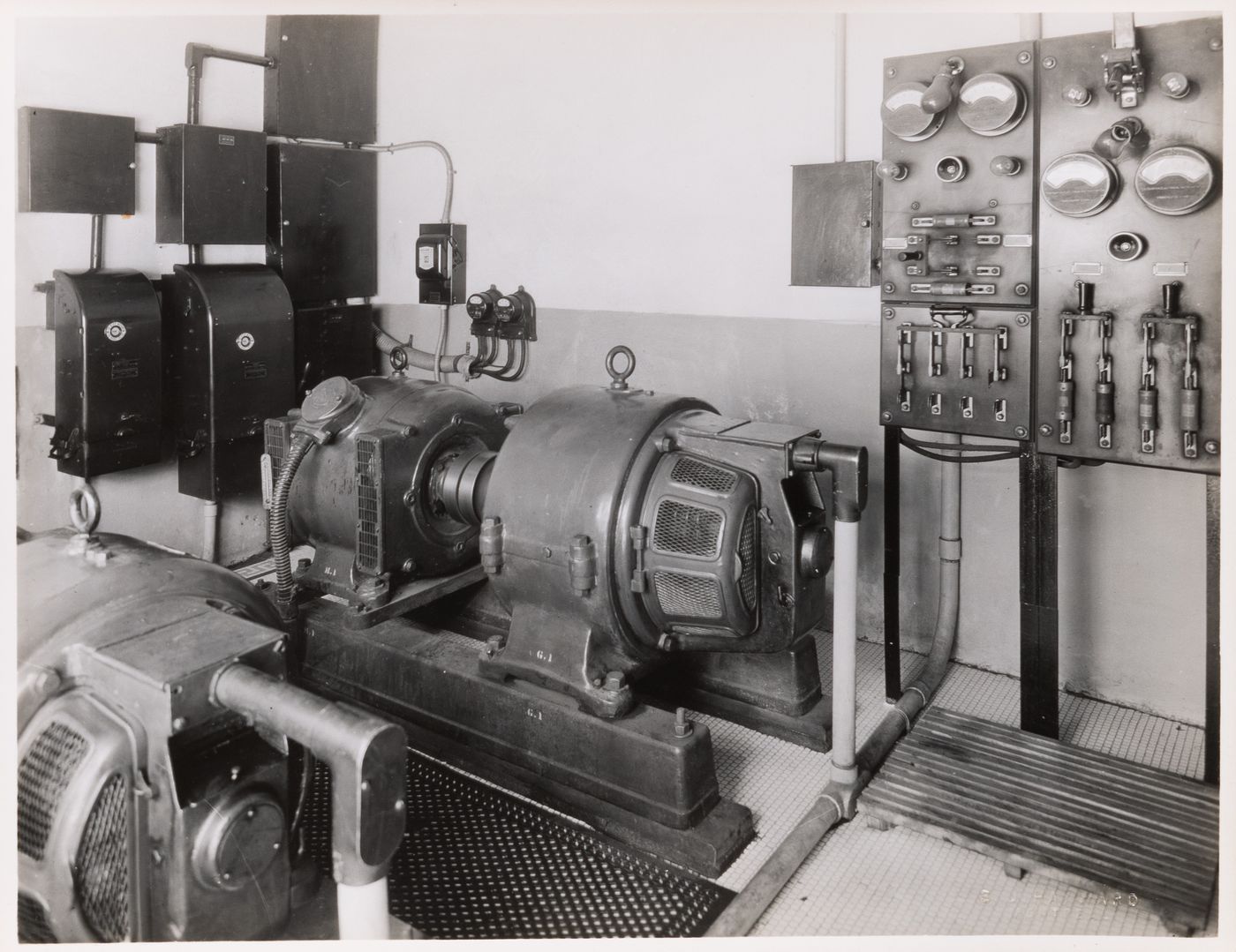 Interior view of the electrical system including generators, switchboards [?], wattmeters, and electric conduits and switches, Édifice de la Sauvegarde, 150-152 rue Notre-Dame Est, Montréal, Québec