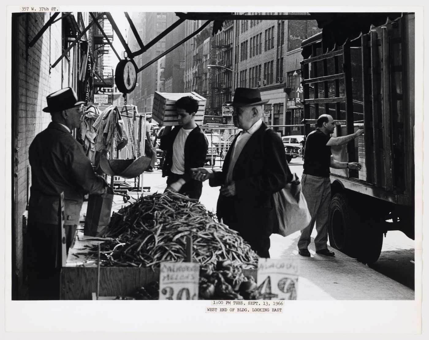 Group portrait of workers and other people showing traffic and buildings, West 37th Street, Manhattan, New York City, New York