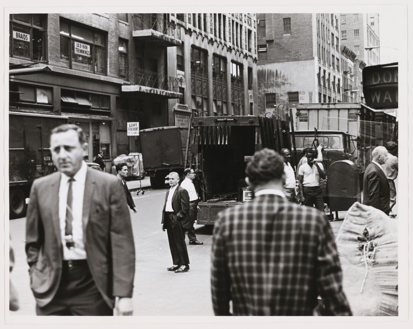 Group portrait of pedestrians and workers showing trucks and buildings, West 37th Street, Manhattan, New York City, New York