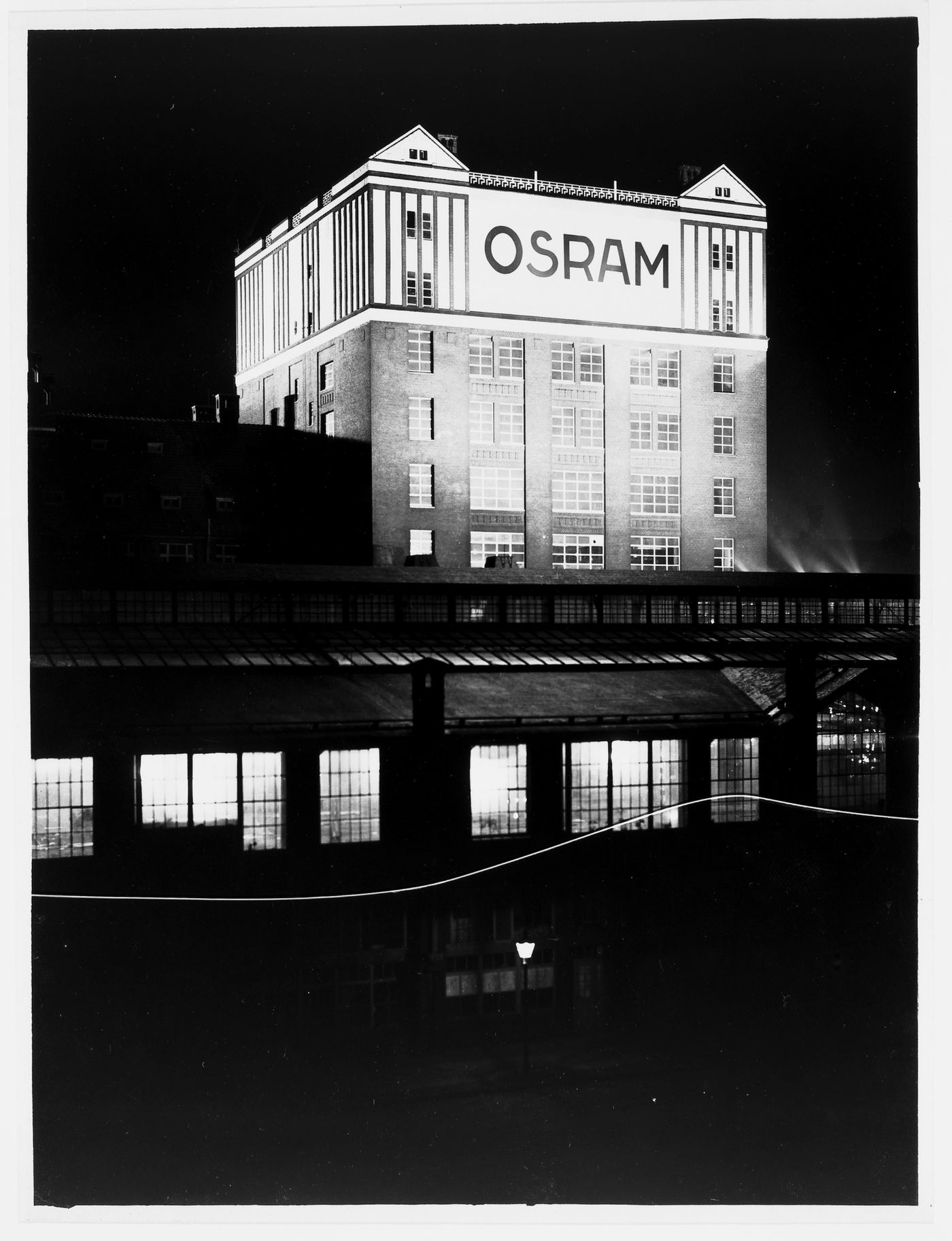 Night view of illuminated Osram building on Rotherstrasse, Berlin, Germany
