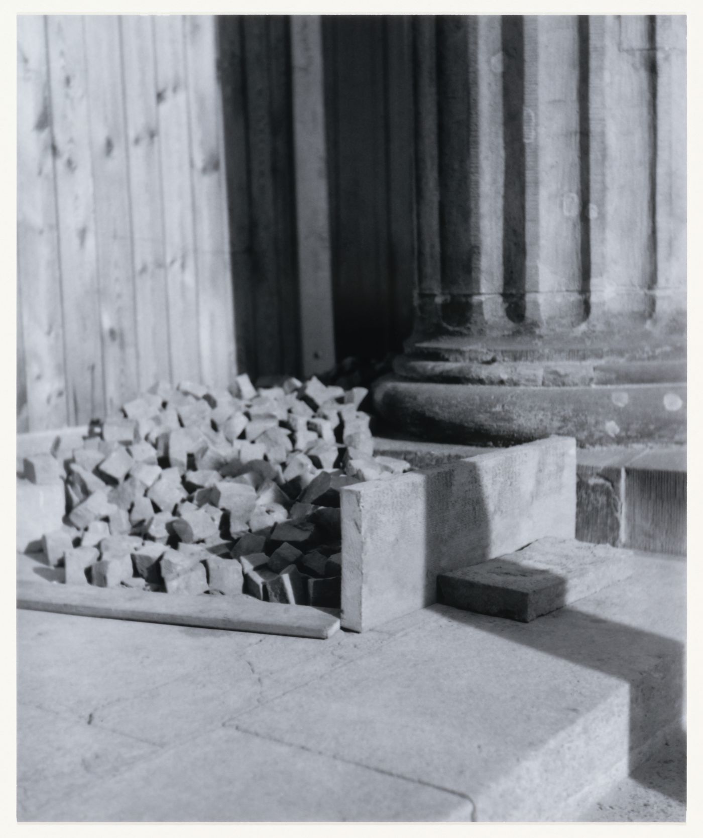 View of stones and building materials, a column, a step and wooden panels, Berlin, Germany, from the artist book "The Potsdamer Project"