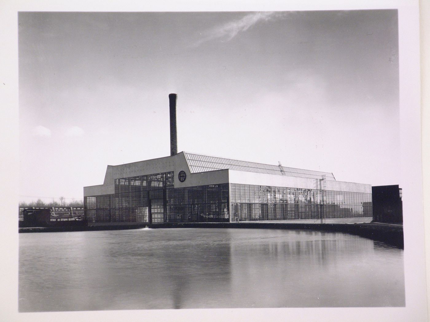 General view of the principal [?] and lateral façades of the Roll and Heavy Machine Shop from across a river [?], Ohio Steel Foundry, Lima, Ohio