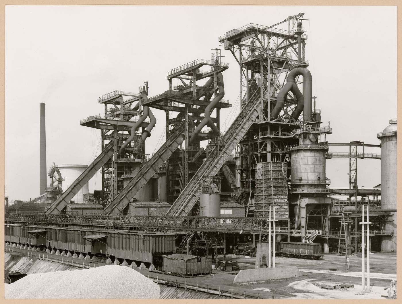 View of Metallhüttenwerk industrial plant showing blast furnace heads A, B, and C, Lübeck-Herrenwyk, Germany