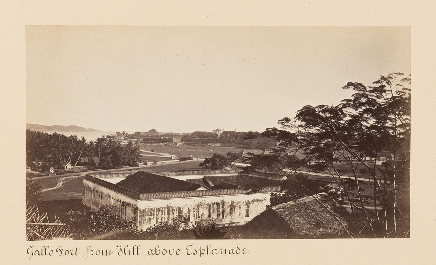 Distant view of Galle Fort from above the esplanade with buildings in the foreground, Point de Galle (now Galle), Ceylon (now Sri Lanka)