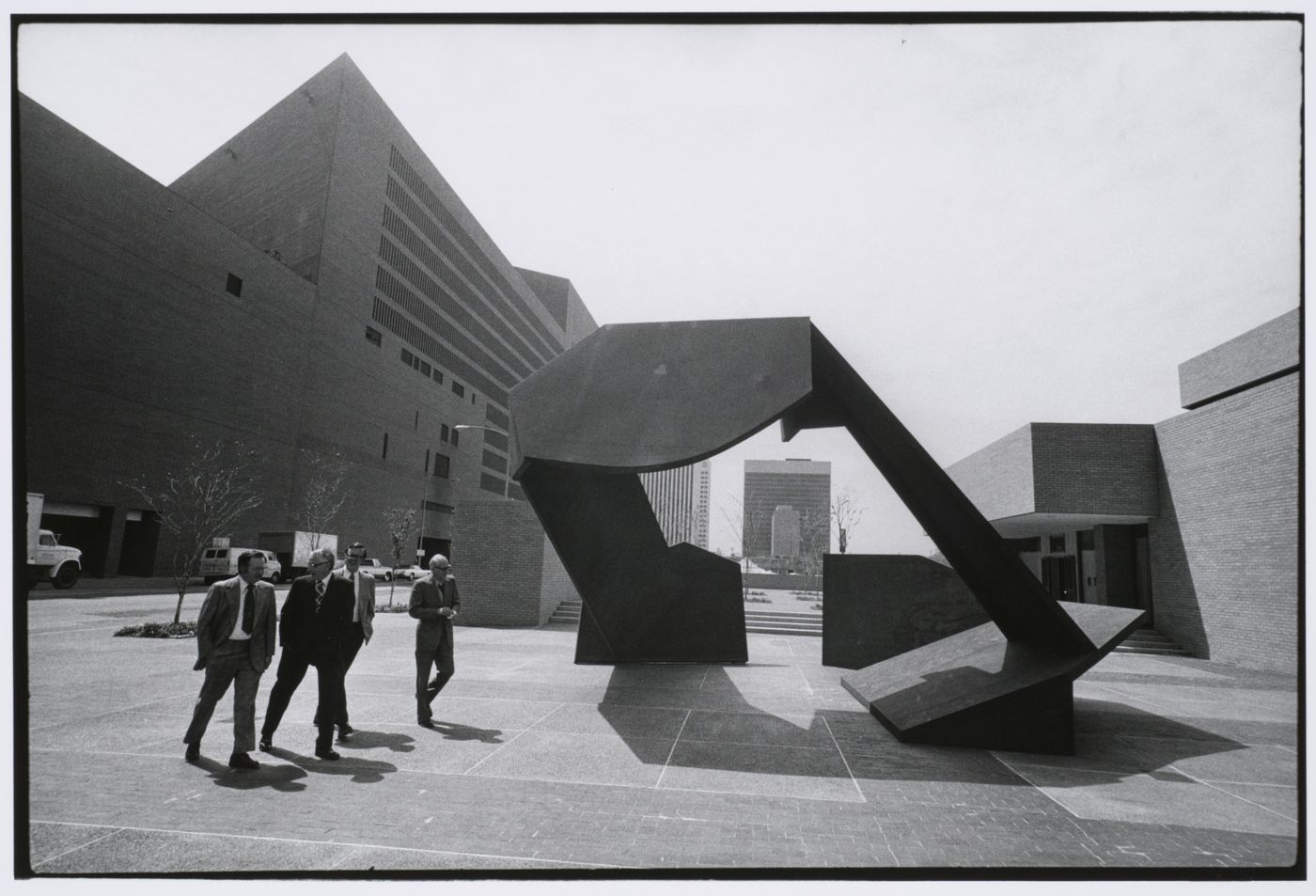 Houston, businessmen on plaza with sculpture