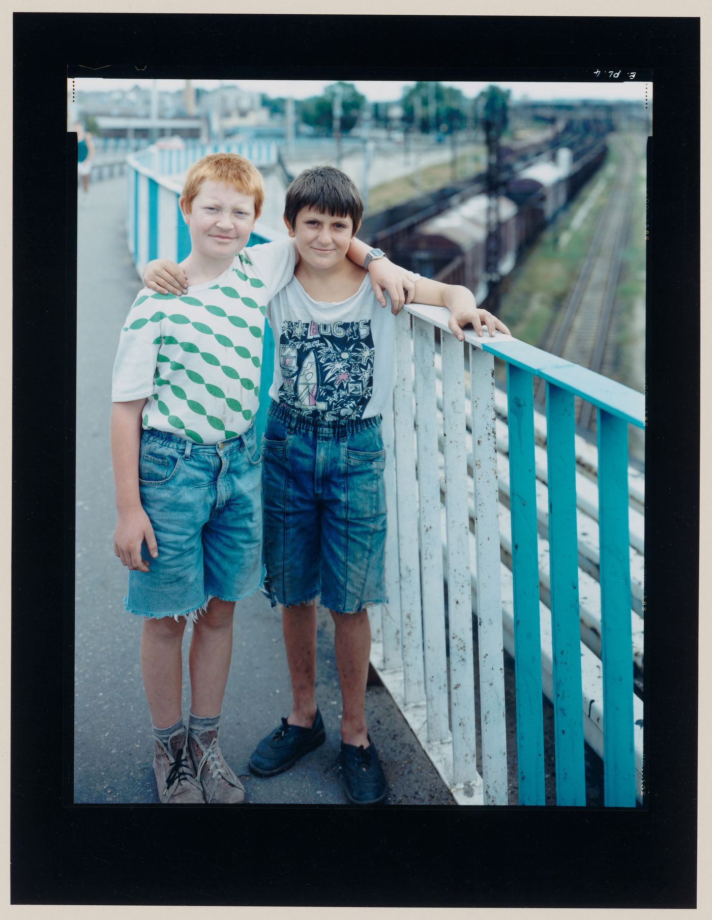 Group portrait of two boys on a bridge over a railway, Malbork, Poland (from the series "In between cities")