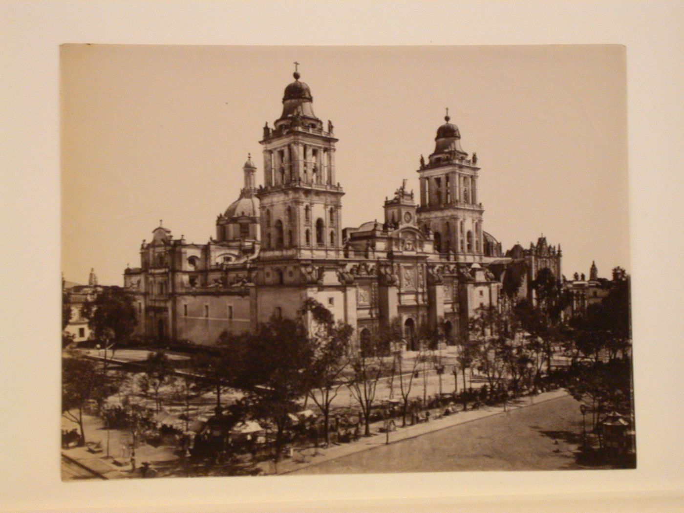 View of the Catedral de México with the Sagrario Chapel on the right and a marketplace and people in the foreground, Mexico City, Mexico