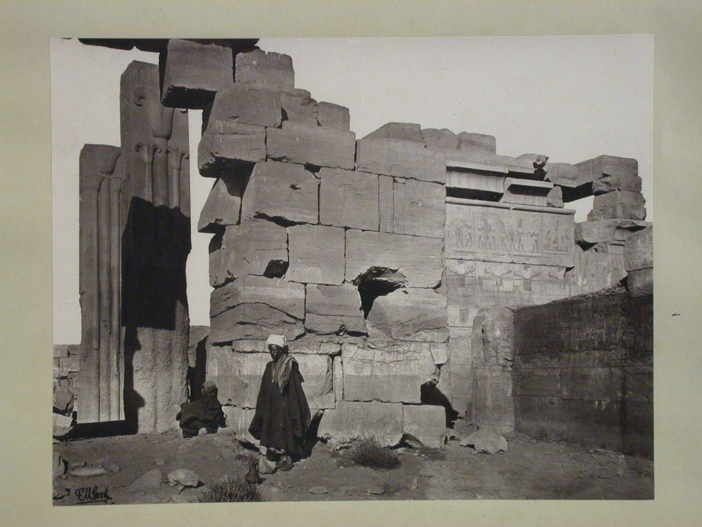 Great Temple of Amun, showing two granite pillars with symbols of Upper and Lower Egypt, on left and outer wall of Granite Sanctuary of Philip Arrhidaeus, Karnak, Thebes, Egypt