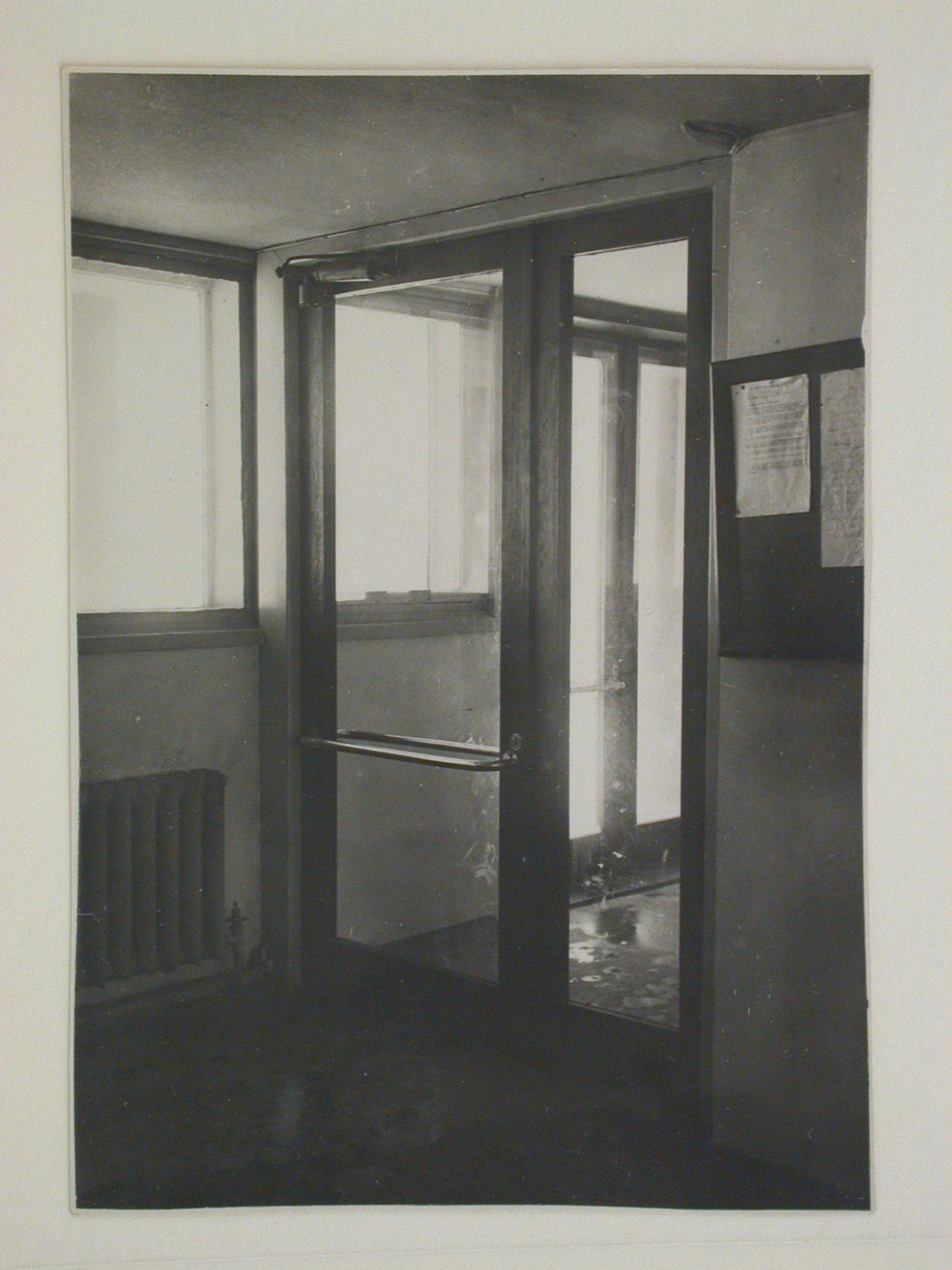 Interior view of an entrance to the People's Commissariat for Finance (Narkomfin) Apartment Building showing a bulletin board, 25 Novinskii Boulevard, Moscow