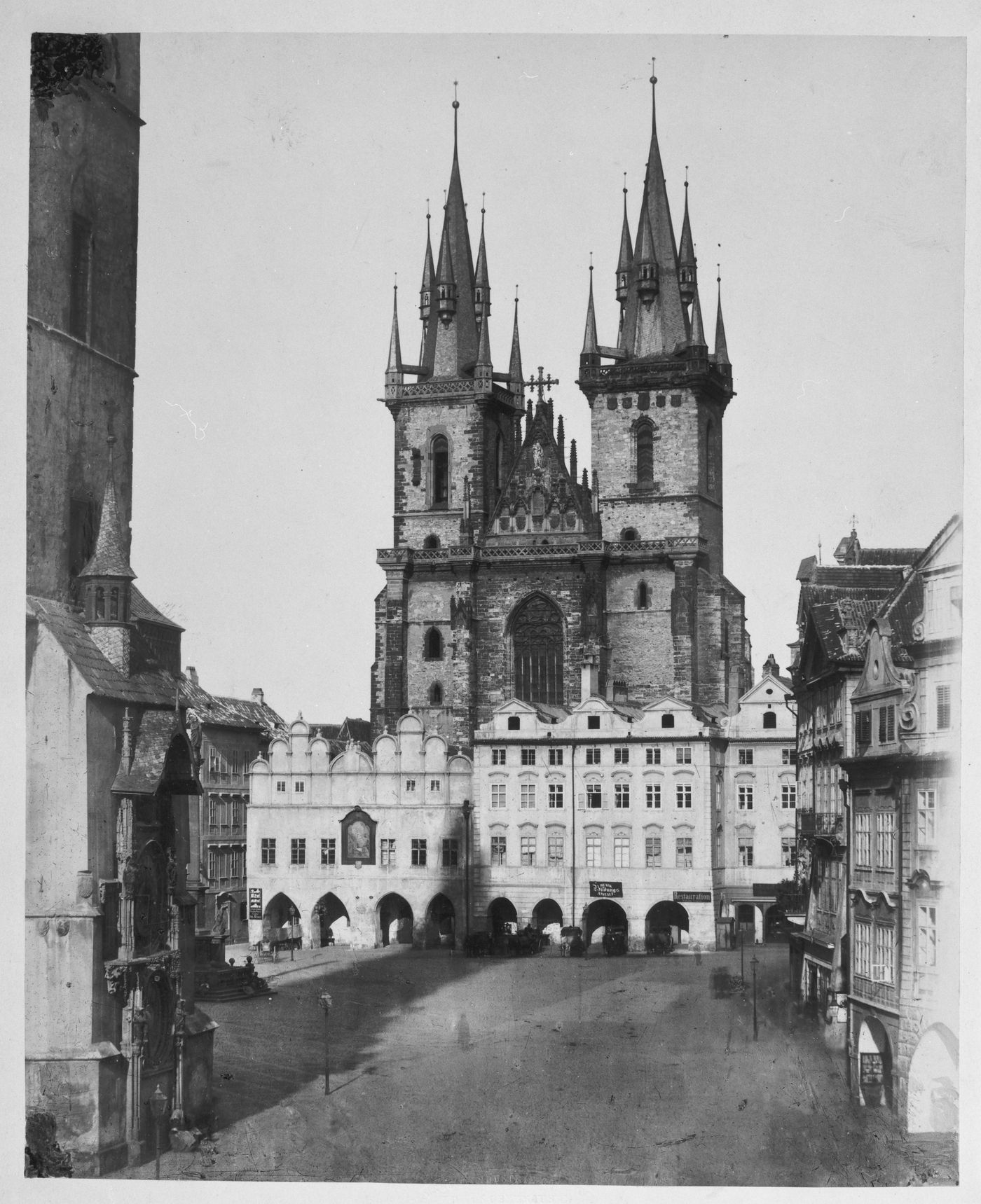 Partial view of upper facade and towers of cathedral, with houses at Hauptmaket in foreground, Trier, Germany