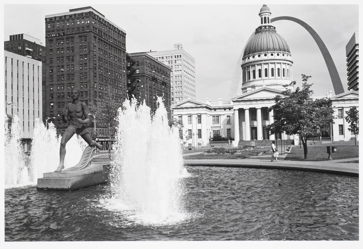 Old Saint Louis Country Courthouse, viewed with fountain and running statue in foreground, and arch behind, Missouri