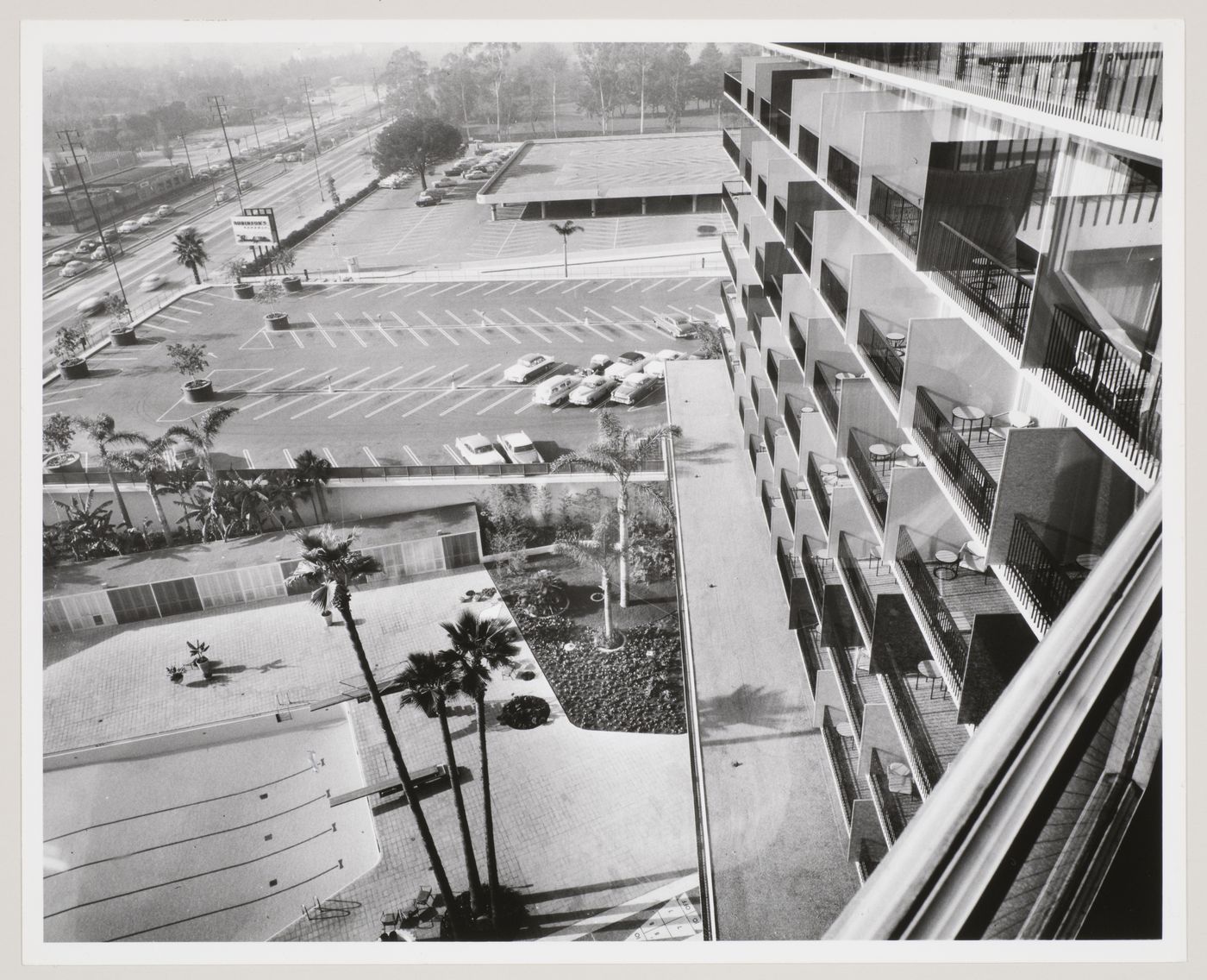 Partial view of the façade, parking lot, and pool at the Beverly Hilton Hotel, Beverly Hills, California, United States