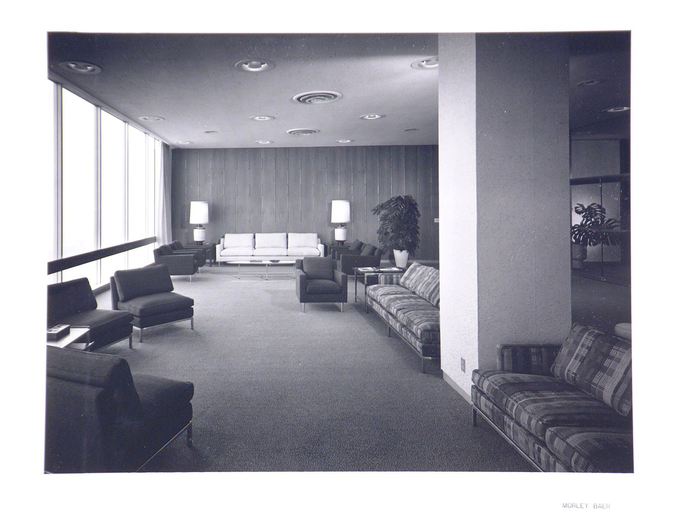 Interior view of an executive lounge in the Kaiser Center office building showing chairs, sofas and table lamps, Oakland, California