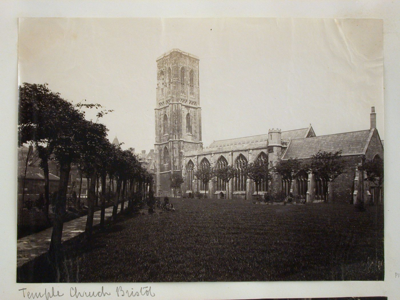 Temple church, façade, with walkway and lawn in foreground, Bristol, England