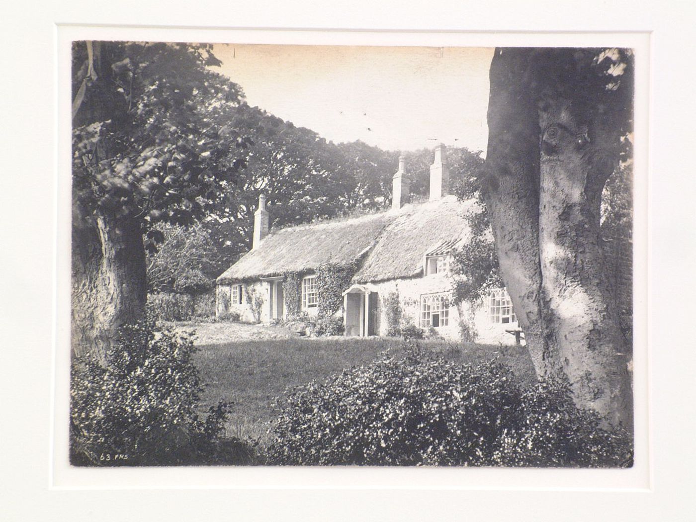 View of cottage with thatched roof, England