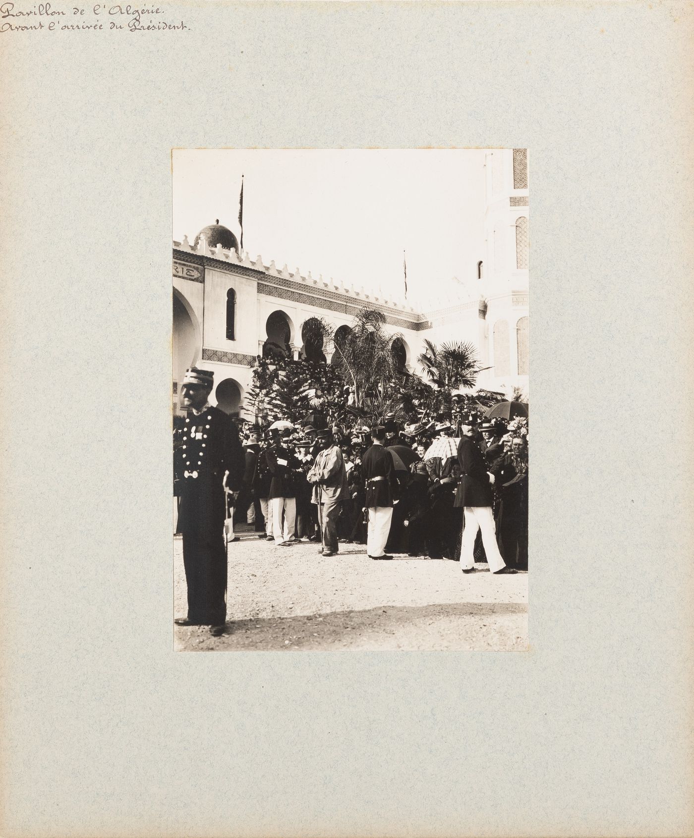 View of crowd being controlled by policemen at Pavillon de l'Algérie during French President Émile Loubet's visit to the Exposition Universelle on opening day, 14 April 1900, Paris, France