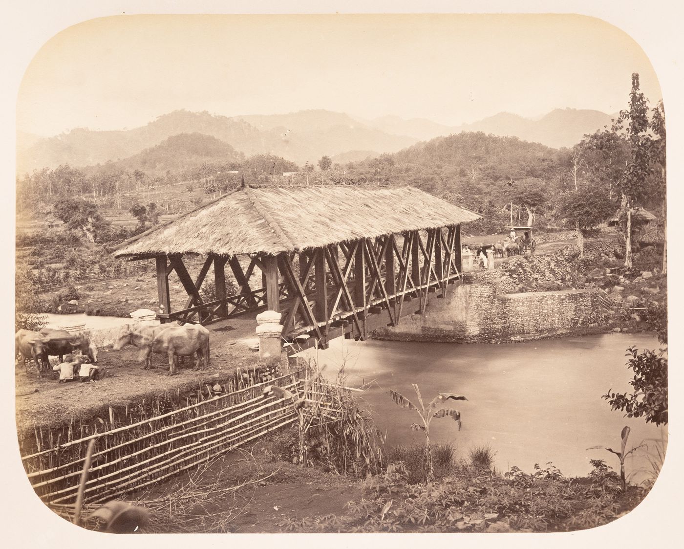 View of a covered bridge over the Manuk River (also known as the Cimanuk River), near Soemedang (now Sumedang), Dutch East Indies (now Indonesia)