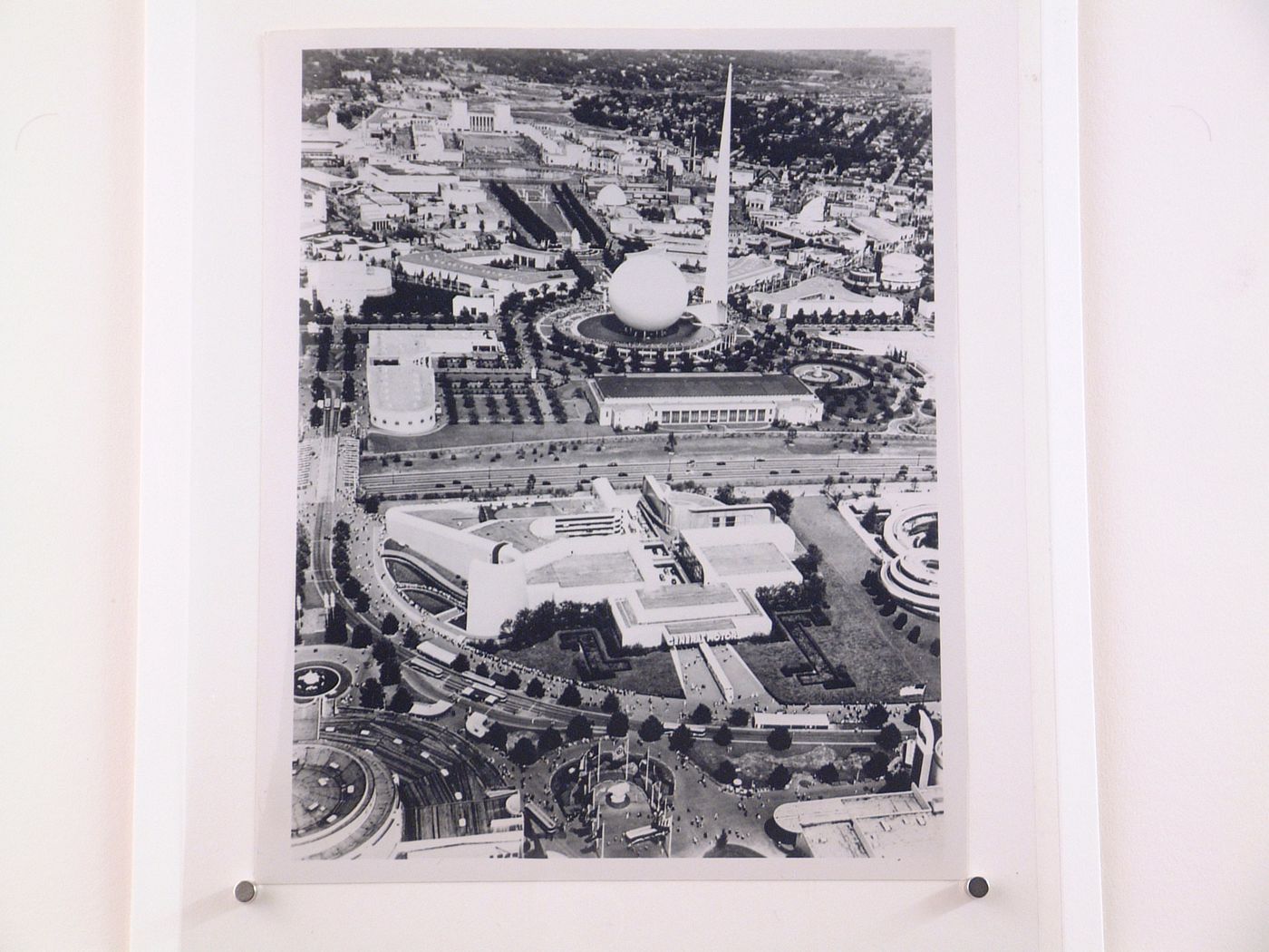 Aerial view of the General Motors Corporation pavilion showing the Trilon and Perisphere in the background, 1939-1940 New York World's Fair, New York City, New York