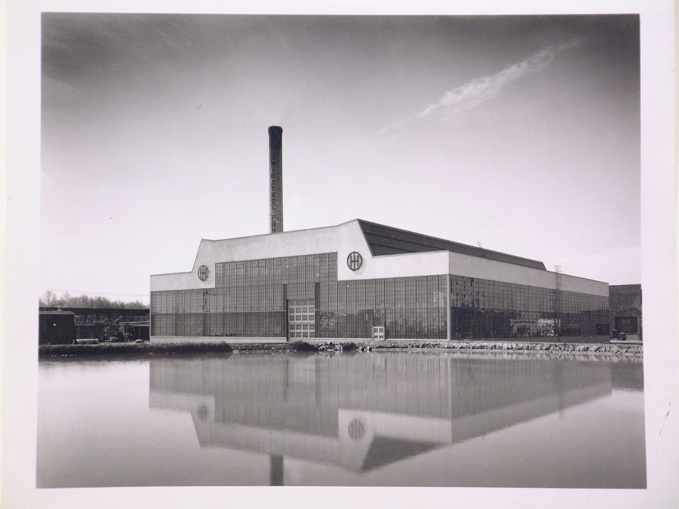 General view of the principal [?] façade of the Roll and Heavy Machine Shop from across a river [?], Ohio Steel Foundry, Lima, Ohio