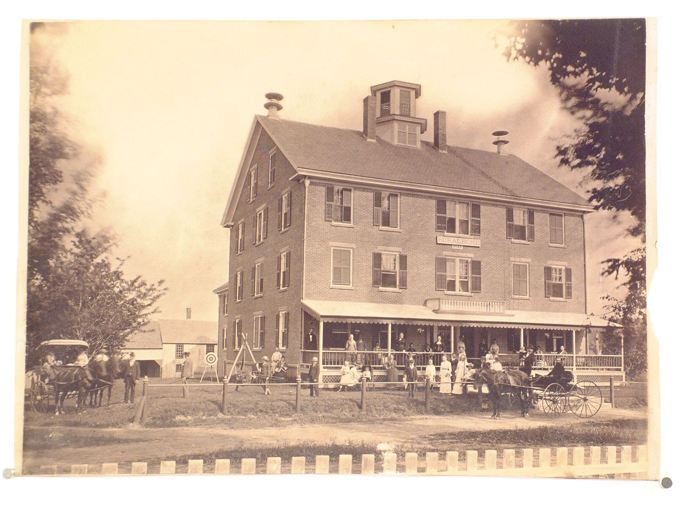 'Rural Home', built in 1853, view of brick house with families out front