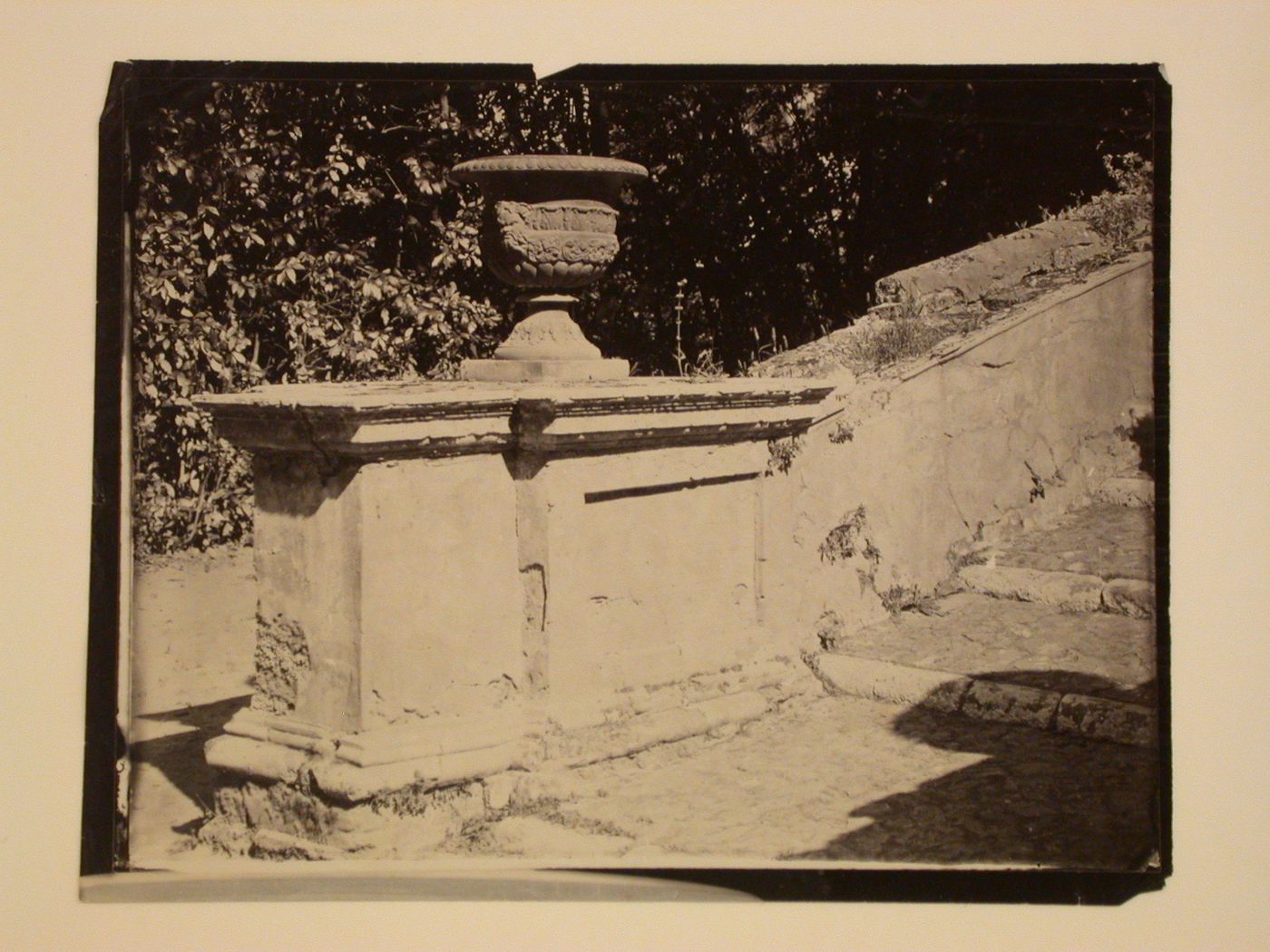 Base of outdoor stairway, with rail and urn, Italy