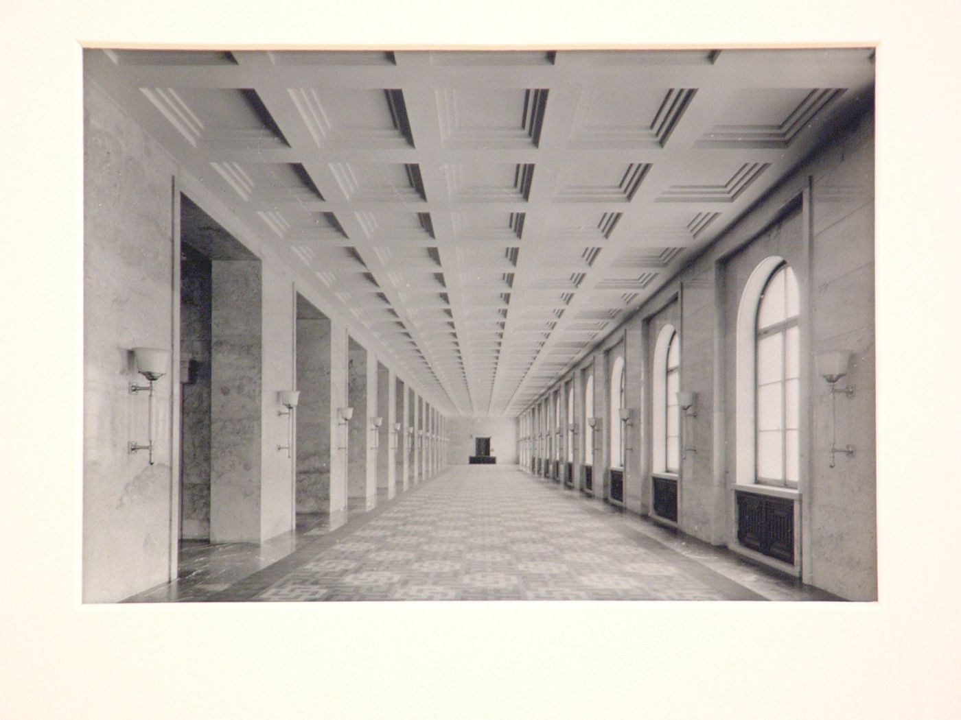 Interior of long gallery with flat, coffered ceiling, and windows at right, Munich, Germany