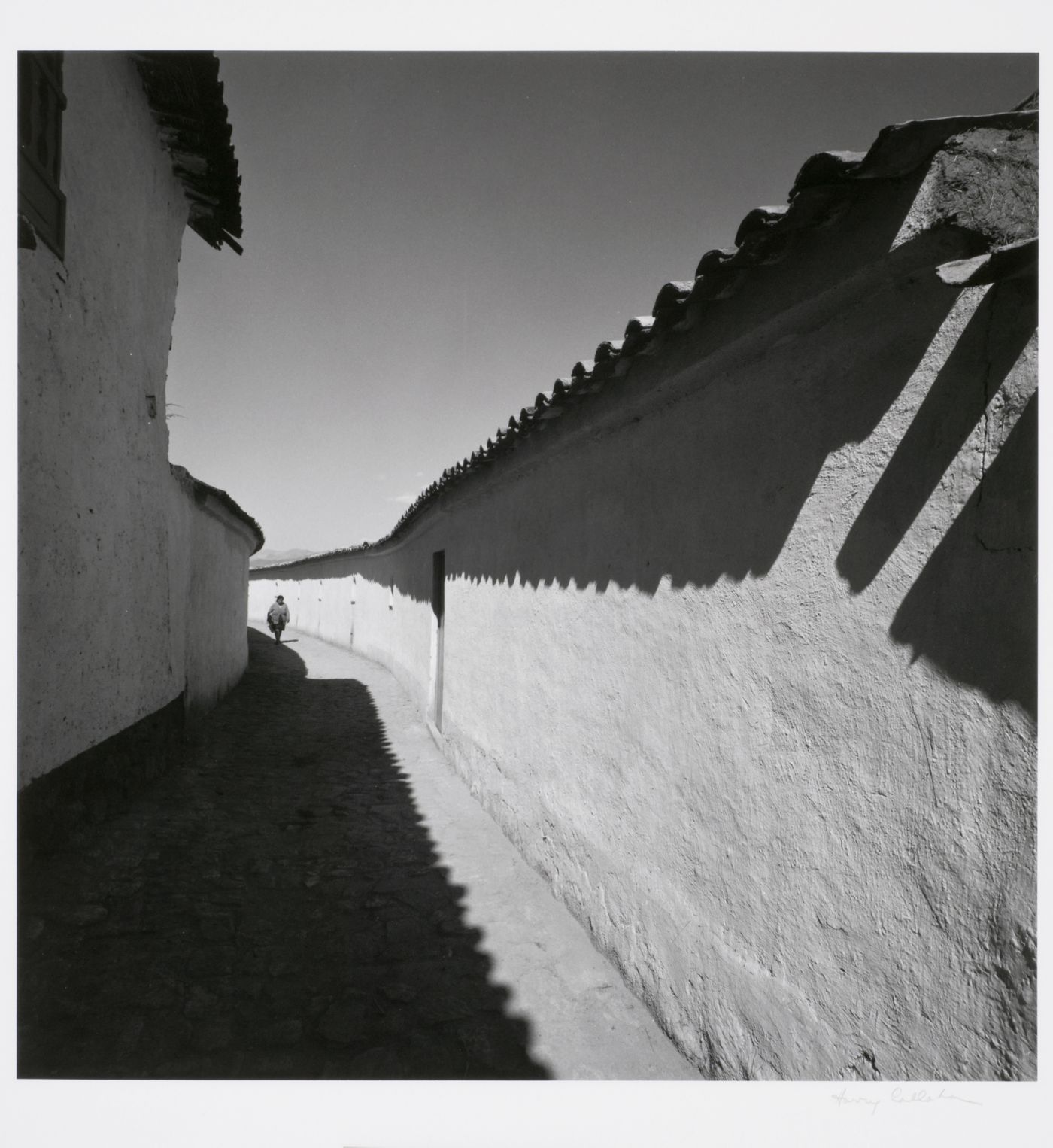 View of a woman walking along an alley, Cuzco, Peru