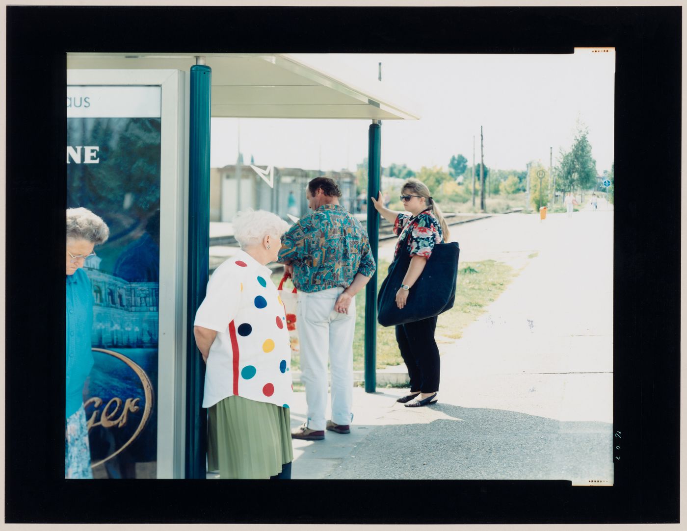 Group portrait of people standing under a canopy at a train station, Magdeburg, Germany (from the series "In between cities")