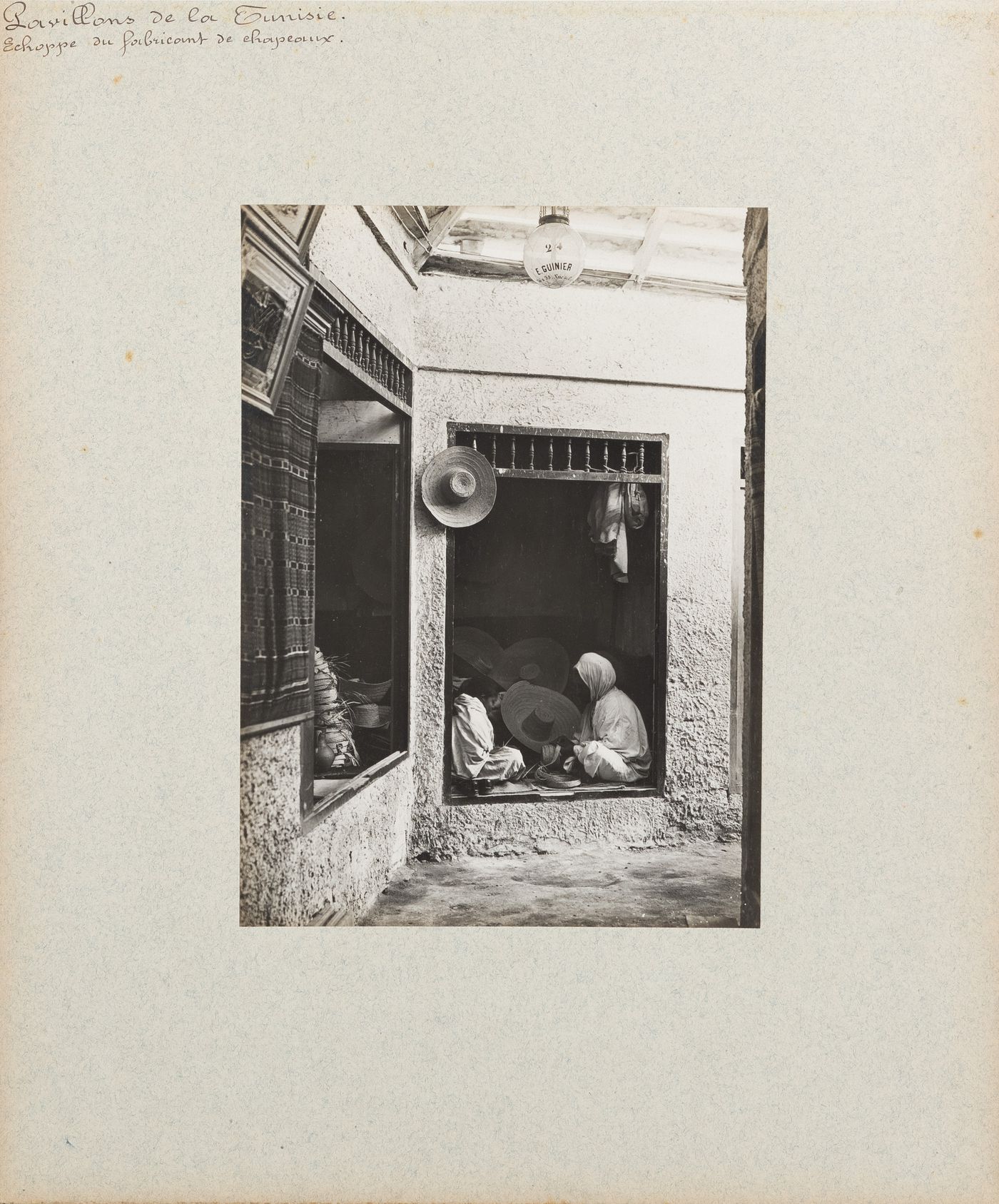 View of two women working in hat maker's shop, Tunisian section, Exposition universelle, 1900, Paris, France