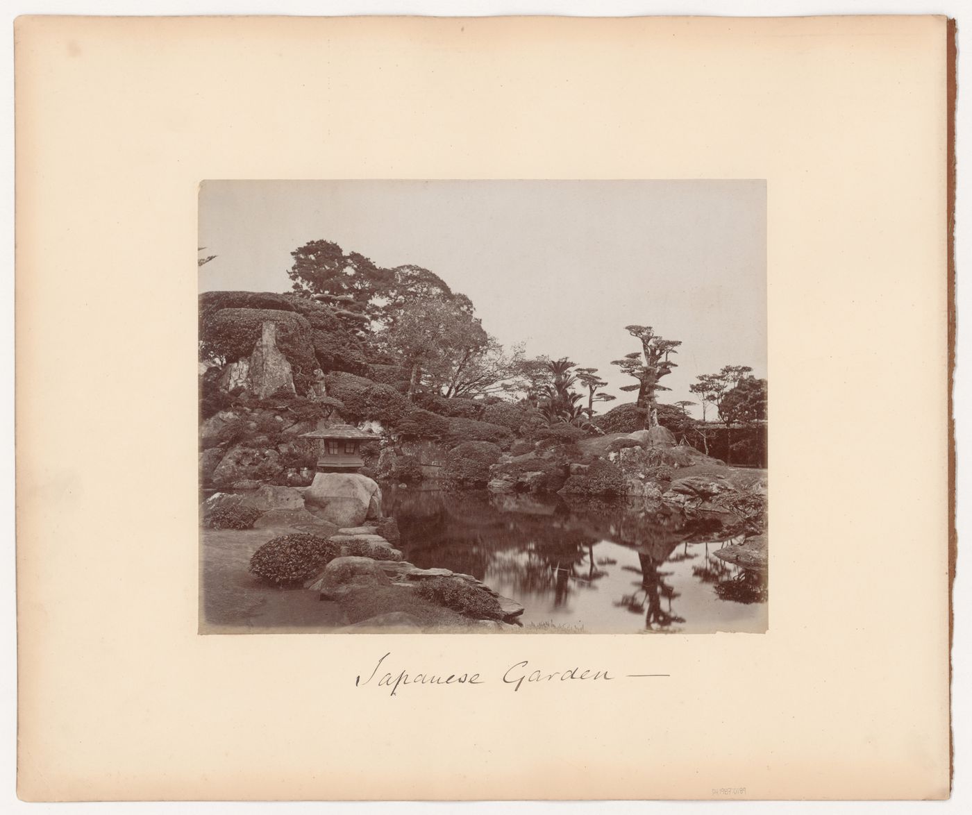 View of a garden showing a pond and a lantern, Japan