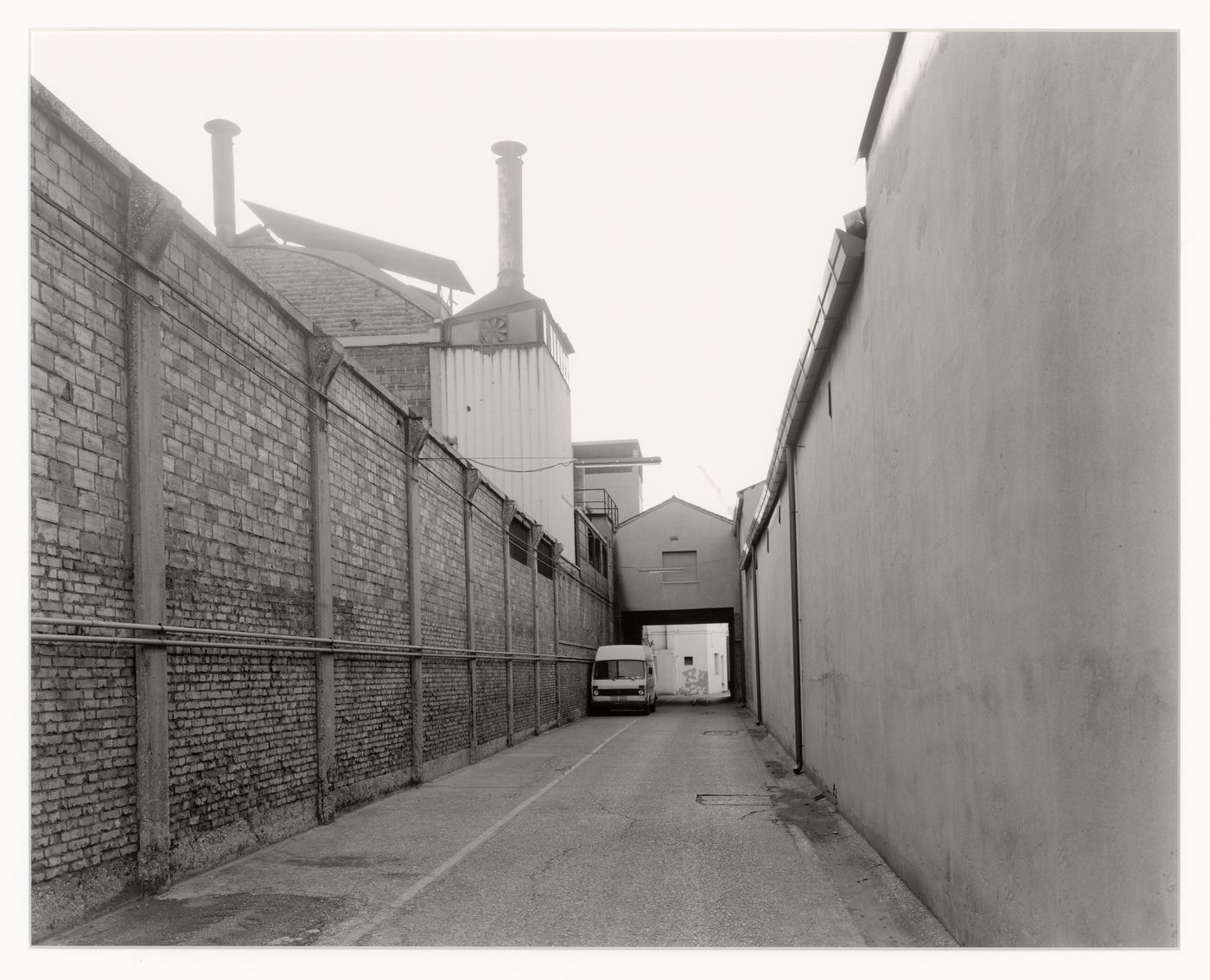 View of a street with walls and buildings on the right and left, Marghera, Italy