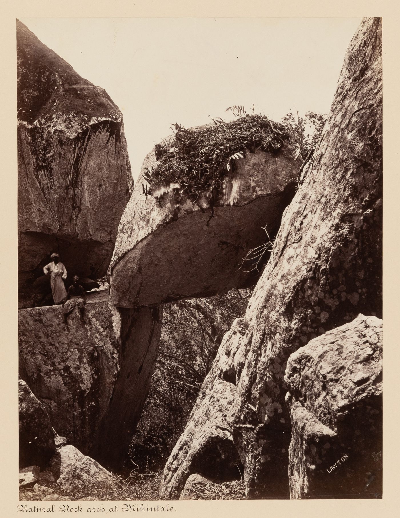 View of a rock resting between two cliffs, Mihintale, Ceylon (now Sri Lanka)