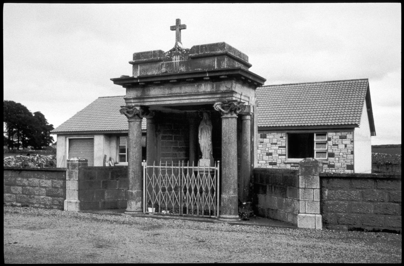 Bungalow behind road-side shrine with statue of The Virgin, Athleague, County Roscommon, Ireland