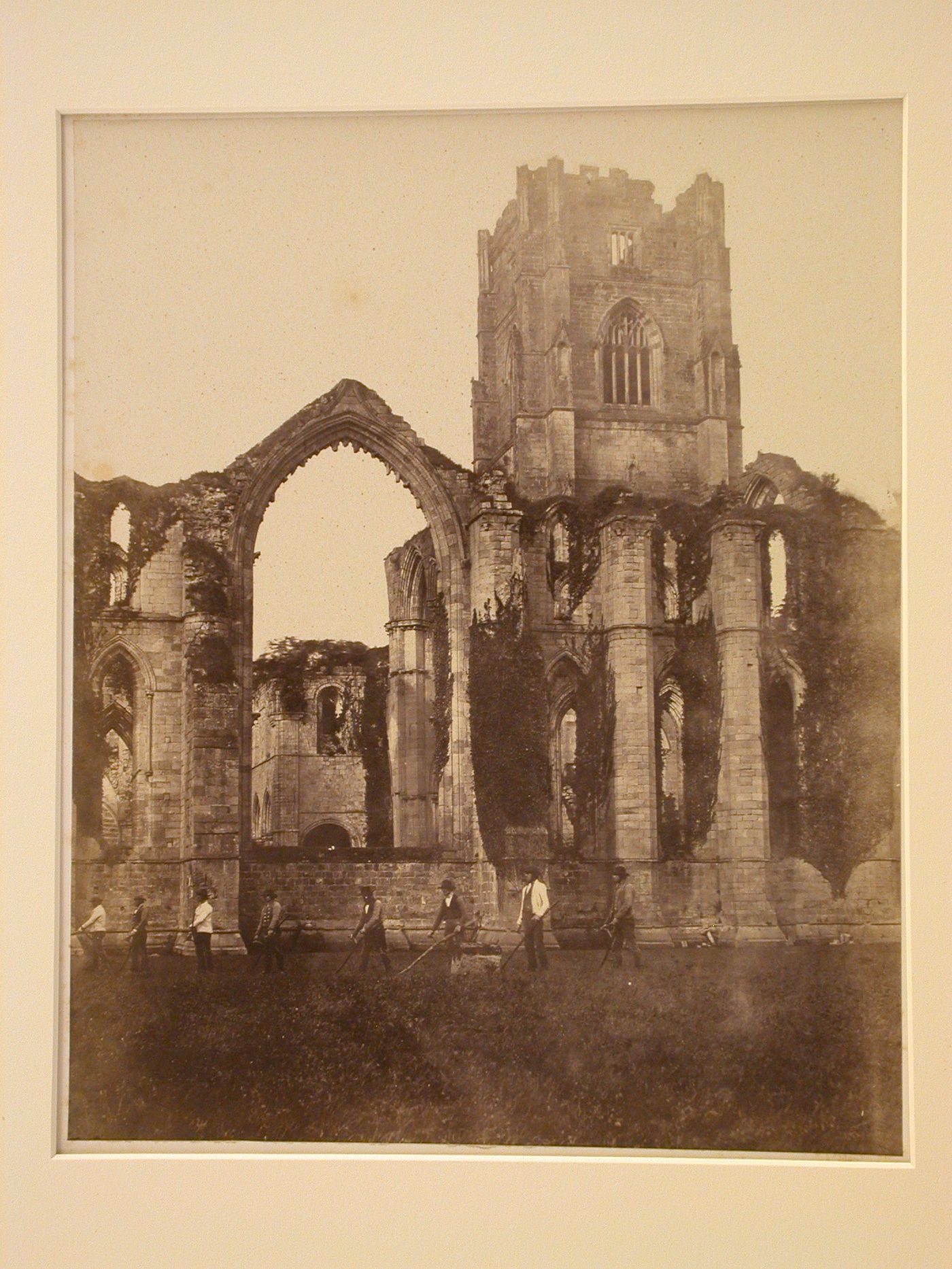 View of ruined nave and tower with figures, Fountains Abbey, North Yorkshire, England