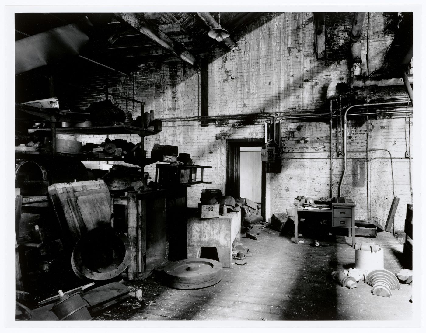 Interior view of the Caledonian Ironworks Building showing shelves of wooden molds in a workshop, Montréal, Québec