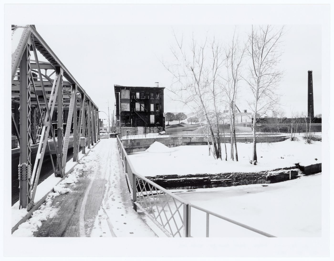 View of the Des Seigneurs Bridge and the Phillips Electrical Works Building from the north bank of Lachine Canal, Montréal, Québec