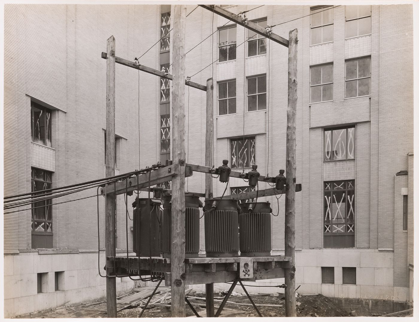 View of the main pavilion of Université de Montréal [?] under construction showing step-down transformers [?] and electric conduits in the foreground, Montréal [?], Québec