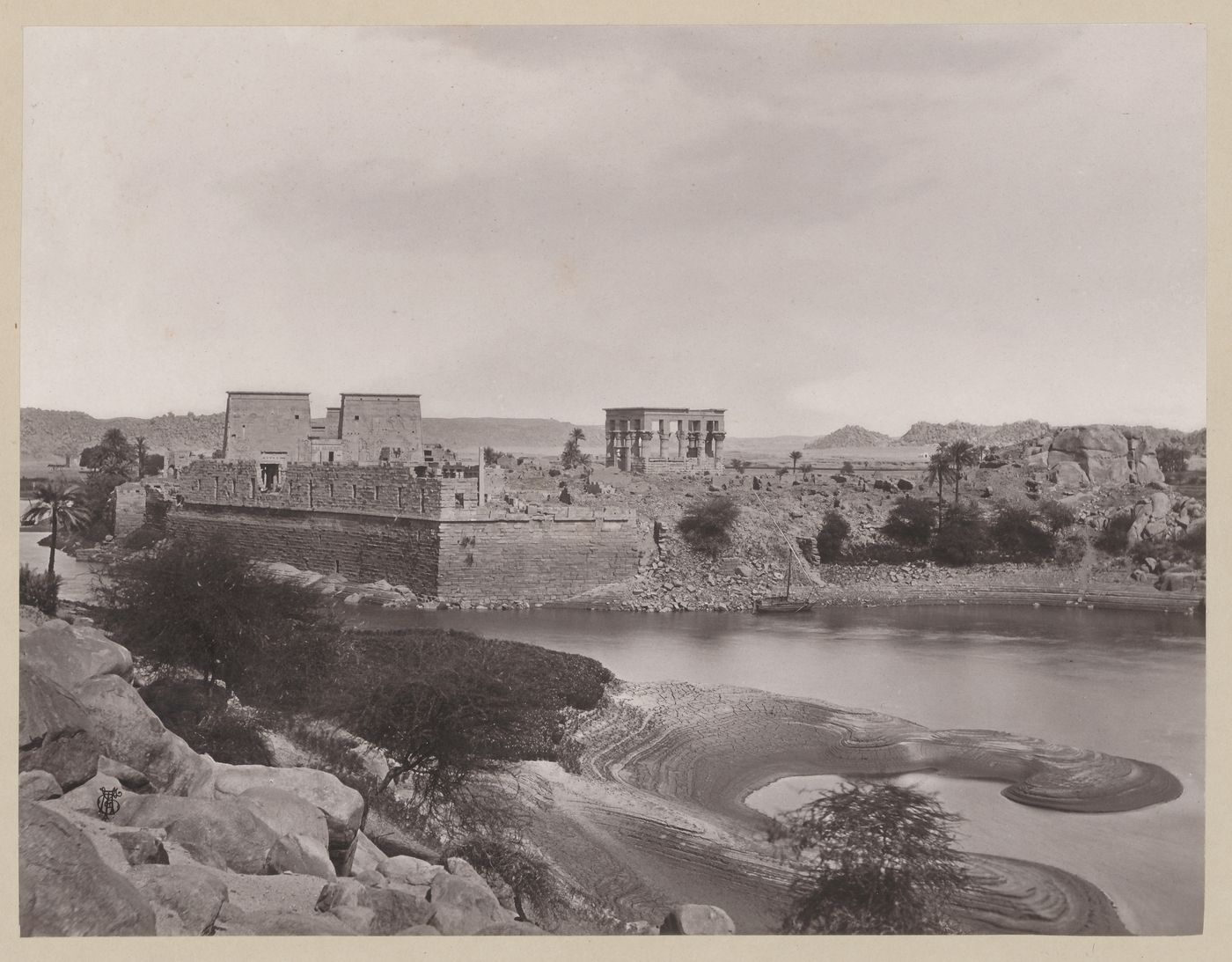 View of Philae from the south taken from Island of Bigah showing quai wall, first pylon of Temple of Isis, and Kiosk of Trajan, Egypt