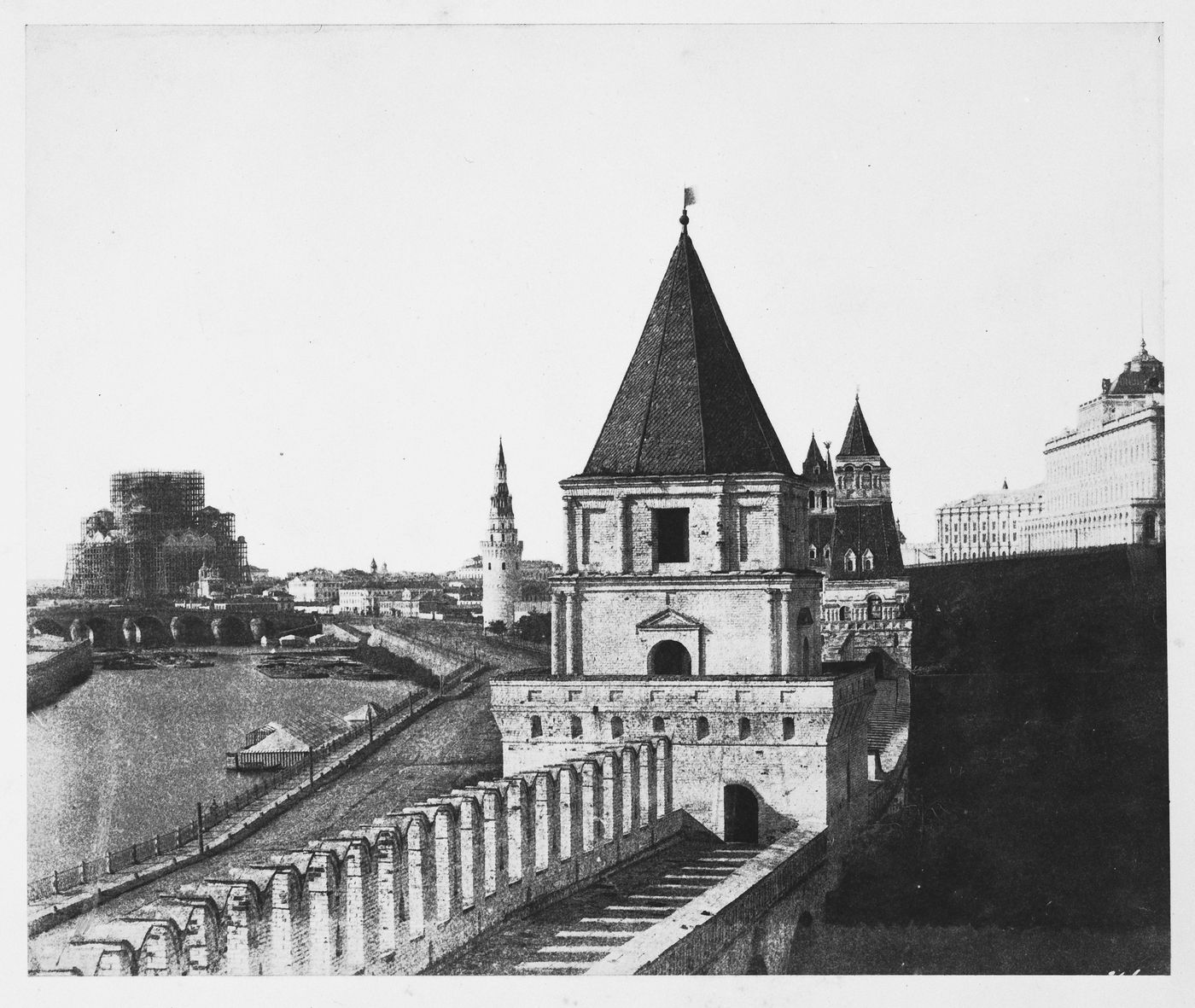 View of the Kremlin Wall and the Second Nameless Tower with the Vodovzvodnaya Tower (Water-pumping Tower) and the Khram Khrista Spasitelia (Temple of Christ the Savior) under construction in the background, Moscow