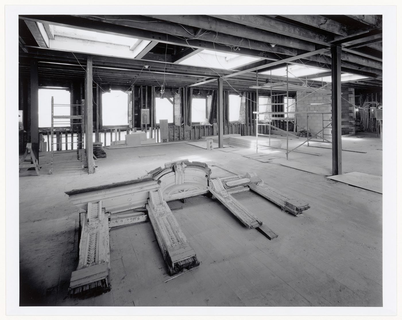 Interior view of level 6 showing the original frame for a Palladian window laid out on the floor for examination [?], Shaughnessy House under renovation, Montréal, Québec
