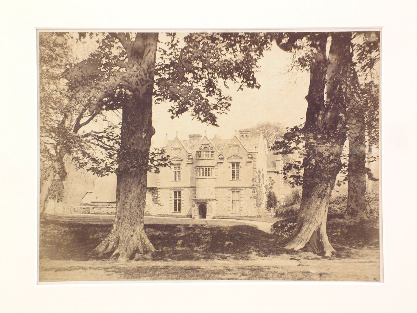 View of a large country house, through trees, Waterson, England