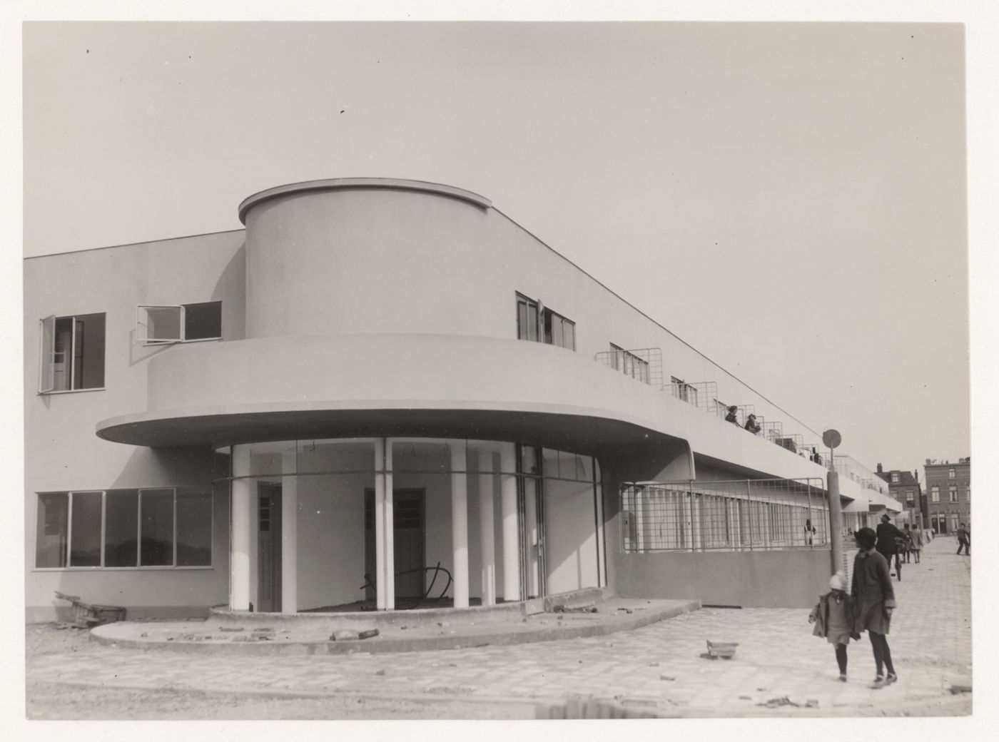 Exterior view of industrial row houses showing a corner store under construction, Hoek van Holland, Netherlands