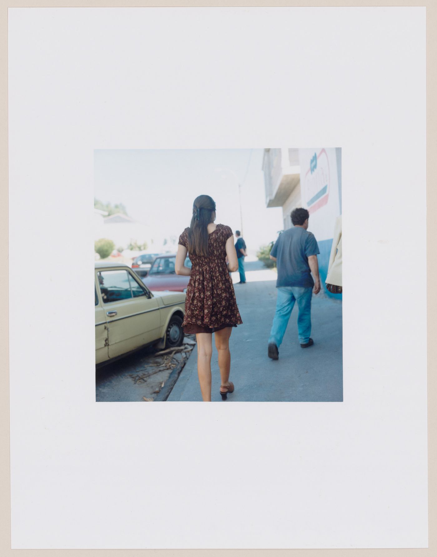 Group portrait of people walking showing parked automobiles and buildings, Paradela, Lugo Province, Spain (from the series "In between cities")