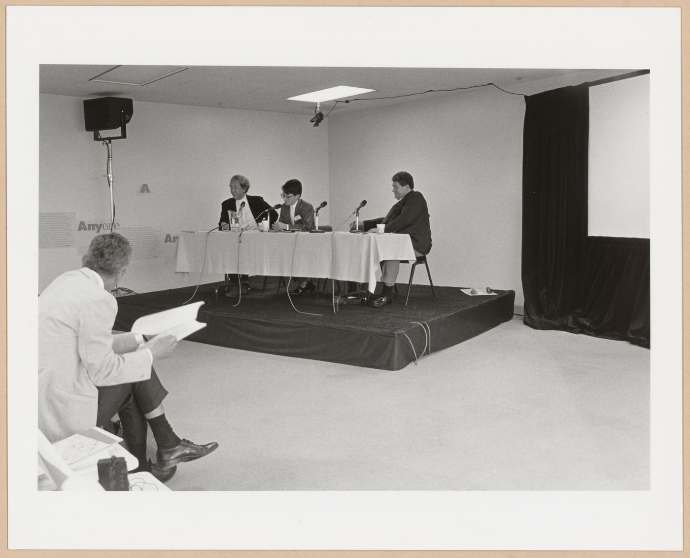 Photograph of Arata Isozaki, Akira Asada and possibly Jeff Kipnis doing a panel at  Anyone Conference