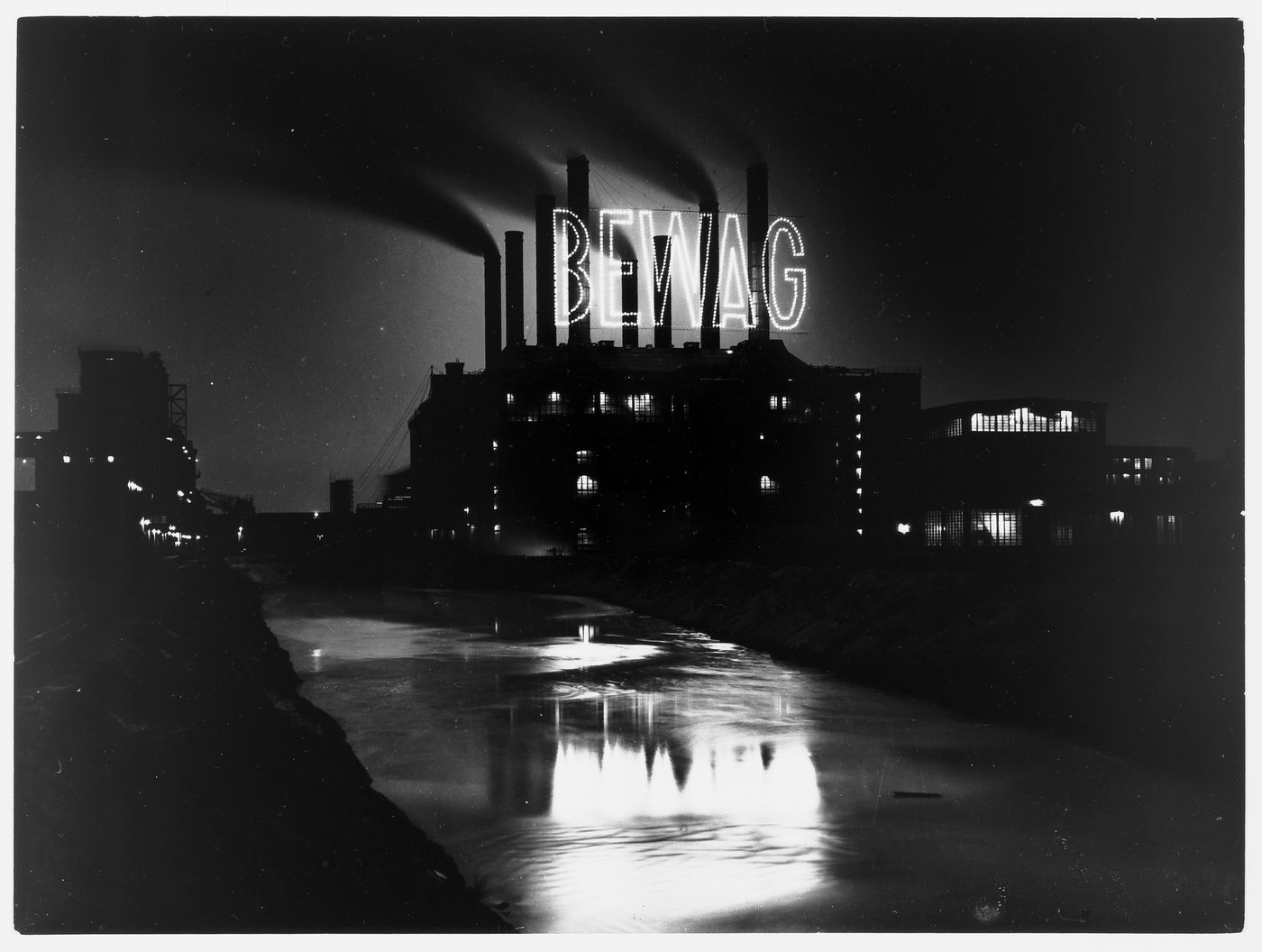 Night view of illuminated sign on factory building, Berlin, Germany