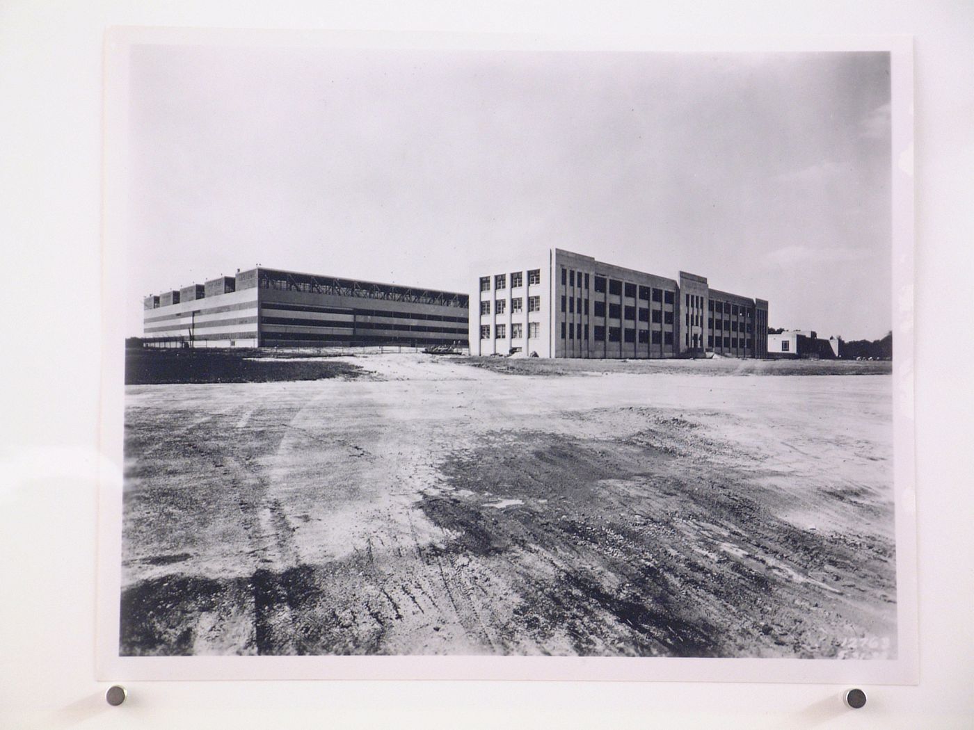 View of the principal and lateral façades of the [second] Assembly Building on the left and the Administration Building in the centre, both under construction, Glenn L. Martin Company Navy Assembly Plant No. 2, Middle River, Maryland