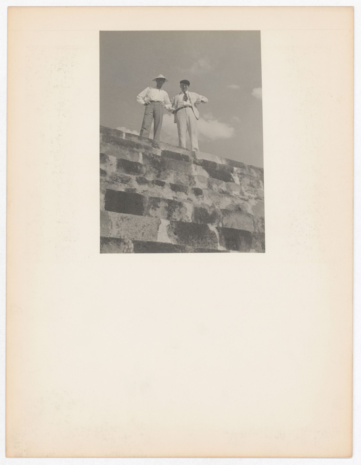 View of Ernest Born and Mr. Squire standing on top of a wall [?], Xochicalco, Mexico